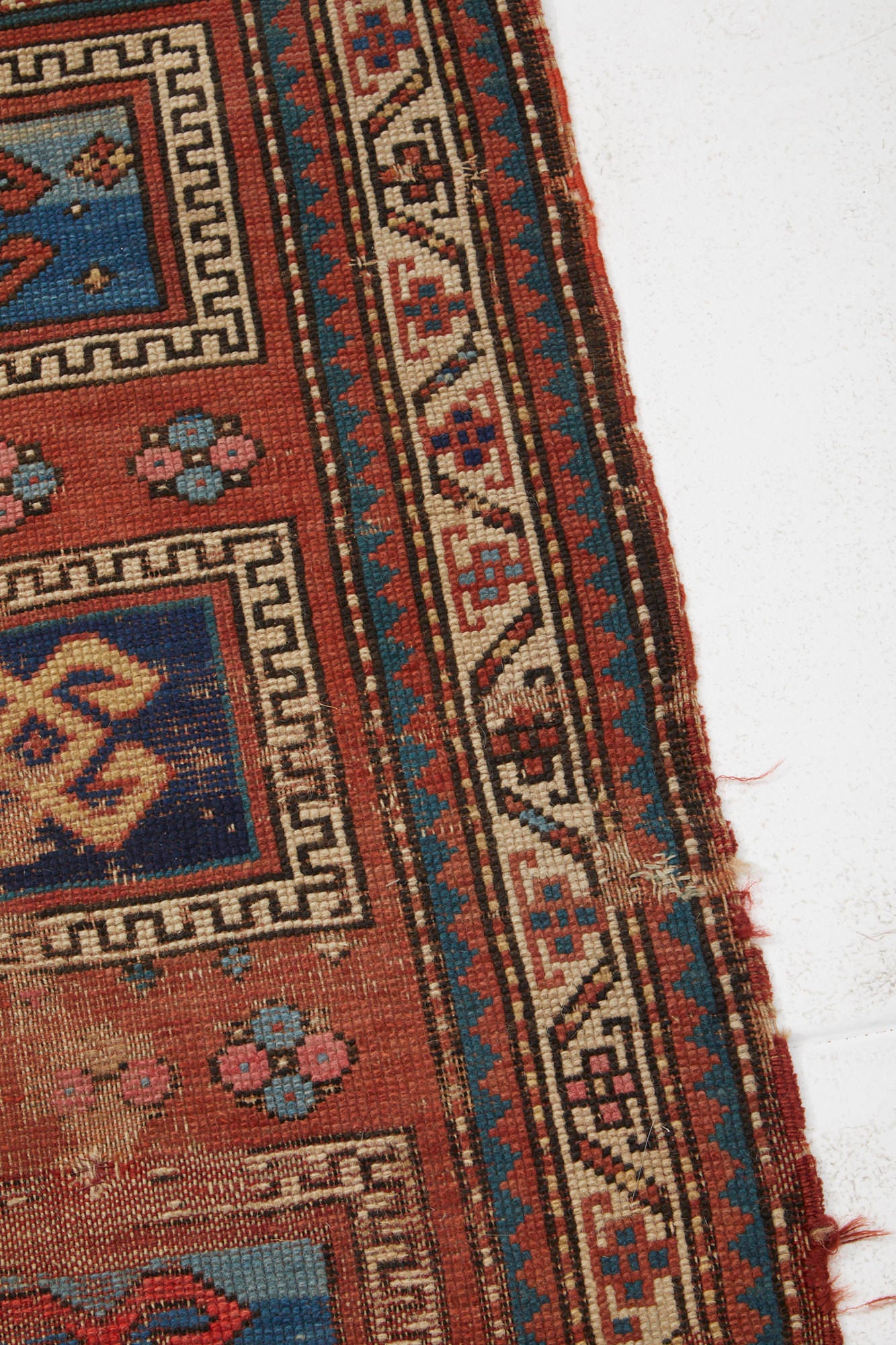 Antique Persian Kazak Prayer rug with pink red base and blue and cream designs - Available from King Kennedy Rugs Los Angeles